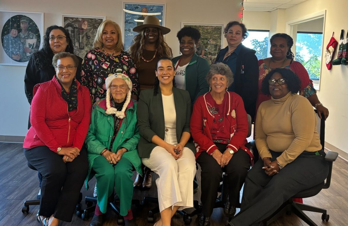 Senator with community women at a holiday gathering